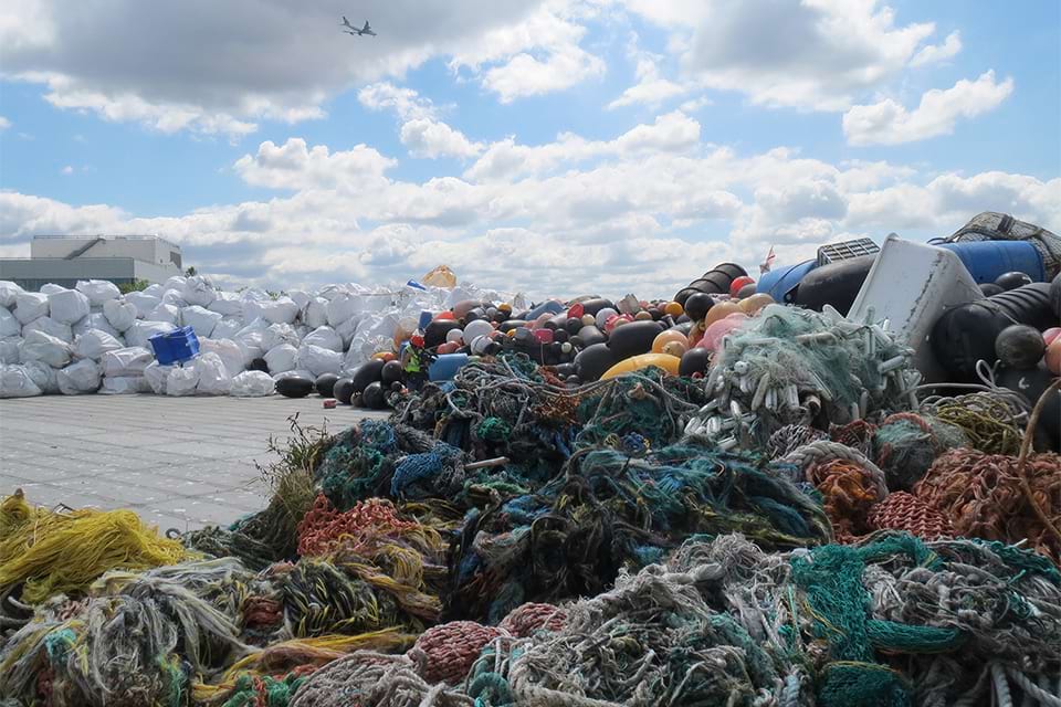 A football-field sized barge carrying nearly 3,400 super-sacks of marine debris from remote and rugged beaches from Alaska and British Columbia docked at the Waste Management facility in Seattle, Washington 