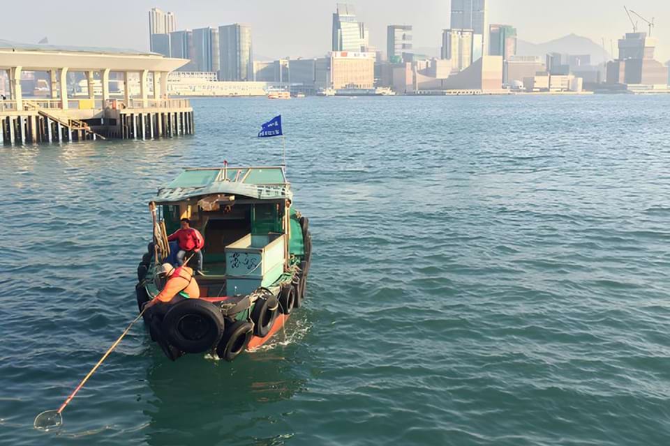 People remove marine debris floating in Hong Kong.
